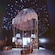 An old parachute hangs in an exhibit with stars projected onto the wall and ceiling
